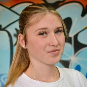 Yasmin Betteridge in front of a graffitied wall